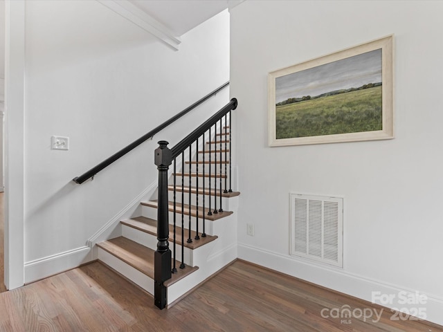 staircase featuring hardwood / wood-style flooring