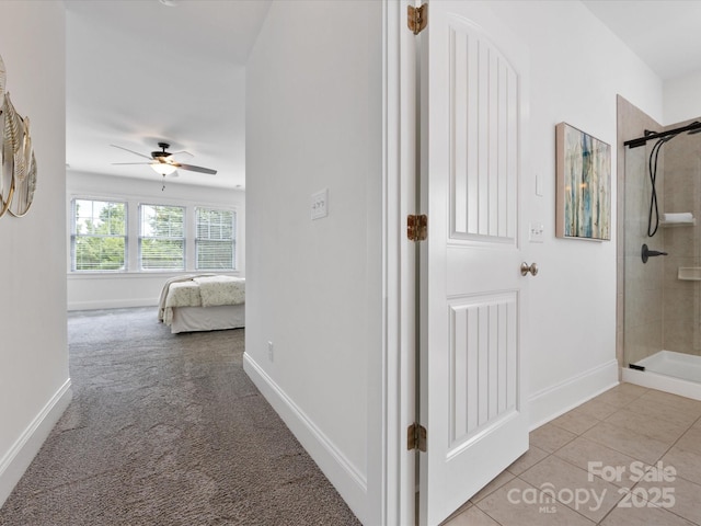 hall featuring light colored carpet