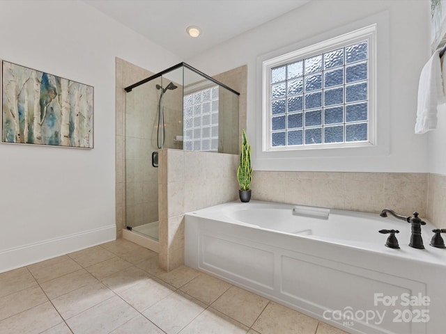 bathroom featuring tile patterned flooring and shower with separate bathtub