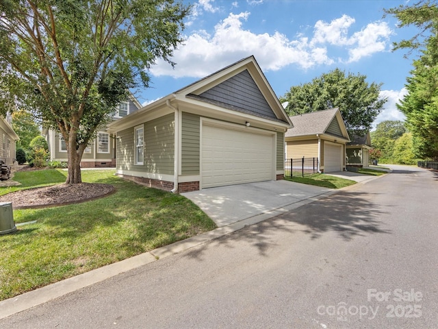 view of front of home with a garage, a front lawn, and an outdoor structure