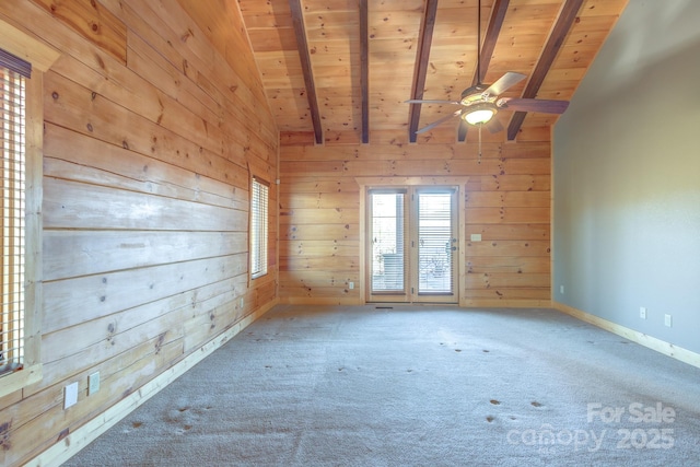 spare room with beamed ceiling, wood ceiling, and wooden walls