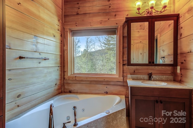 bathroom with vanity, tiled bath, and wooden walls