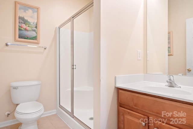 bathroom with tile patterned floors, vanity, toilet, and a shower with shower door