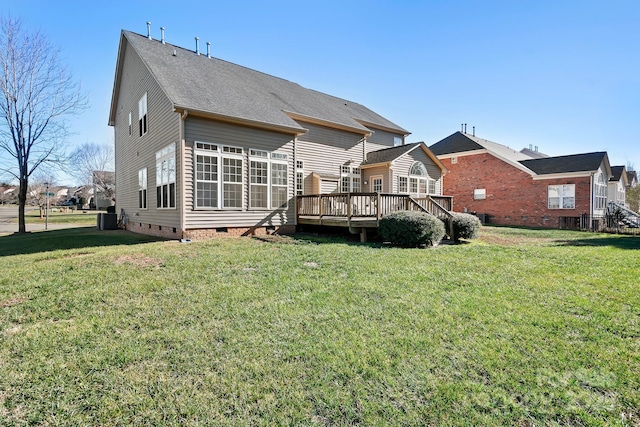 rear view of house with central air condition unit, a yard, and a wooden deck