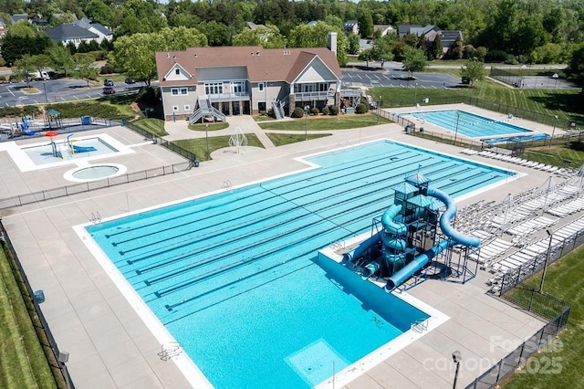 view of swimming pool featuring a patio area and a water slide