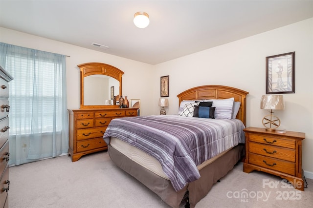 bedroom featuring light carpet