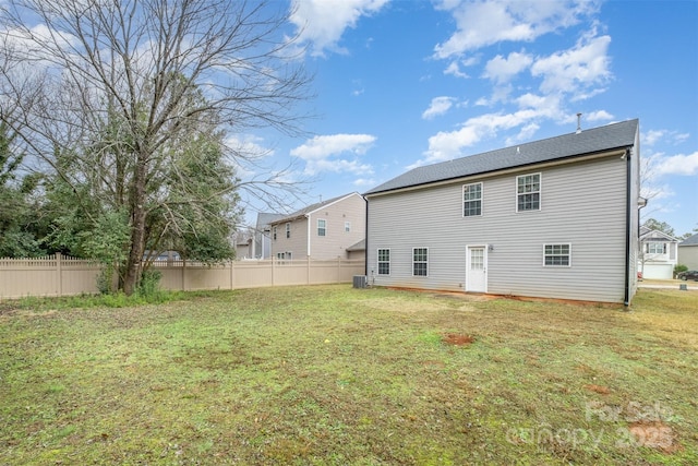 back of property with a yard and cooling unit