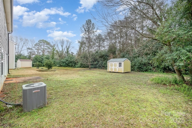 view of yard featuring central AC and a shed