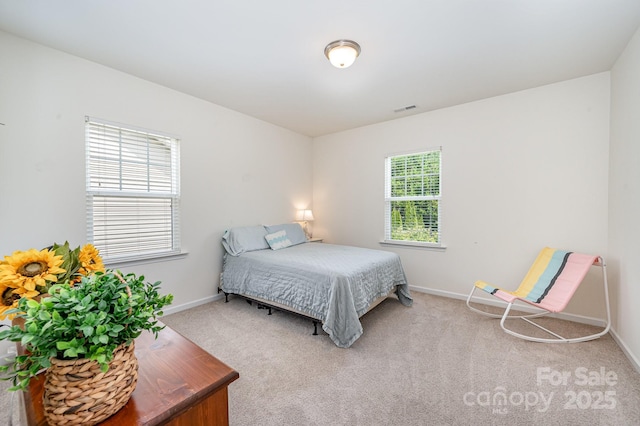 carpeted bedroom featuring multiple windows