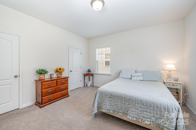 bedroom featuring light carpet