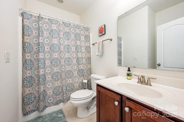 bathroom featuring tile patterned floors, vanity, and toilet