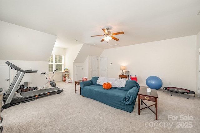 workout area with ceiling fan, light carpet, and vaulted ceiling