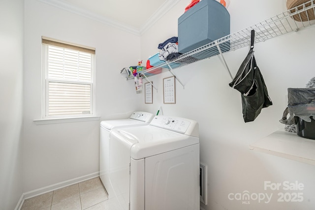 clothes washing area featuring crown molding, light tile patterned floors, a healthy amount of sunlight, and independent washer and dryer