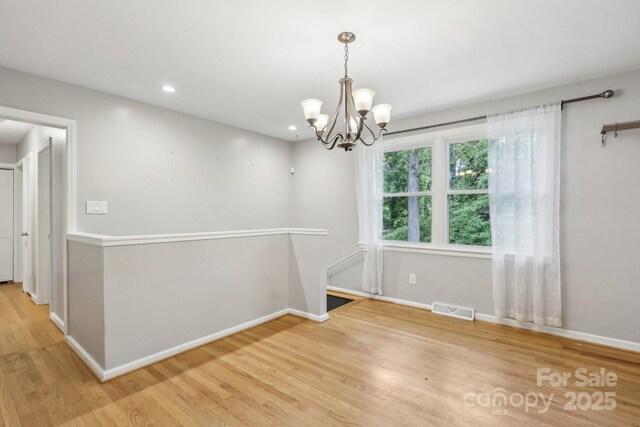 132 30th Ave NW, Hickory, NC 28601 - spare room with light wood-type flooring, a chandelier, baseboards, and recessed lighting
