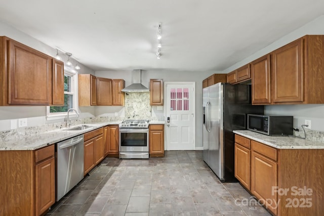 132 30th Ave NW, Hickory, NC 28601 - kitchen with appliances with stainless steel finishes, a sink, wall chimney exhaust hood, brown cabinetry, and light stone countertops
