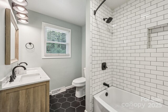 132 30th Ave NW, Hickory, NC 28601 - bathroom with double vanity, toilet, bathing tub / shower combination, tile patterned flooring, and baseboards