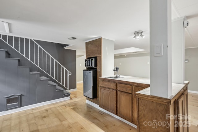 132 30th Ave NW, Hickory, NC 28601 - bar with a sink, light wood-style flooring, and stairway