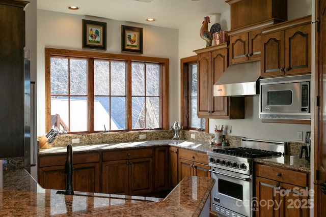 kitchen featuring stainless steel appliances and light stone countertops