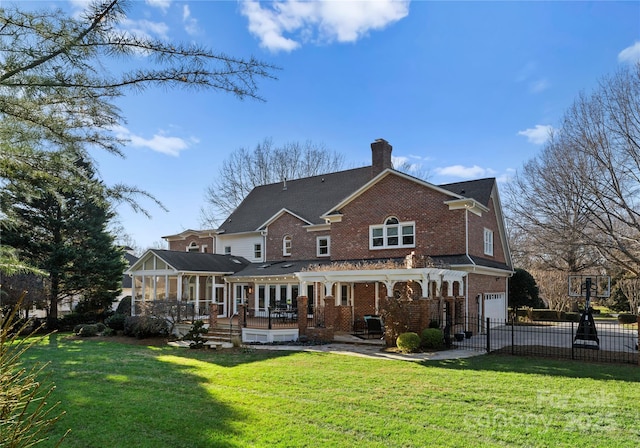 rear view of house with a lawn, a pergola, a sunroom, and a garage