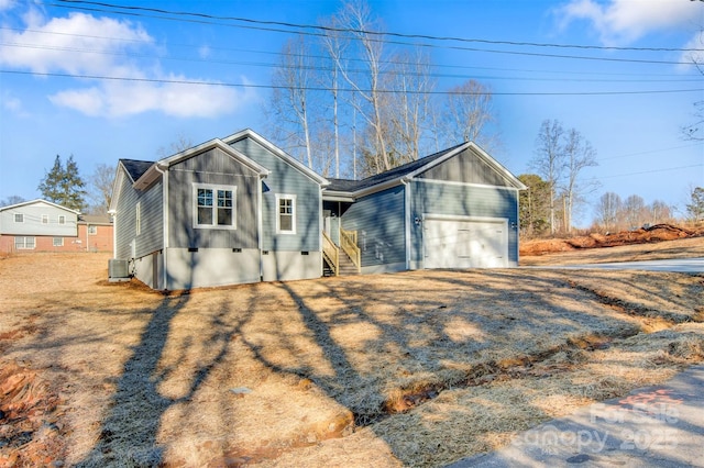 view of front of home with central AC and a garage