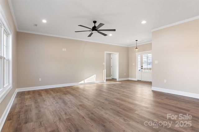 empty room featuring hardwood / wood-style flooring, ceiling fan, and ornamental molding