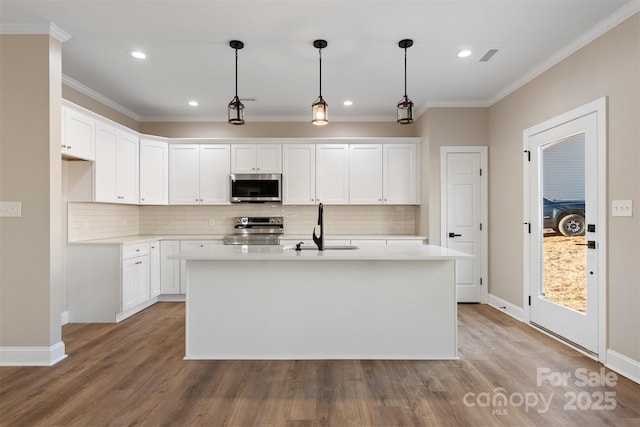 kitchen featuring appliances with stainless steel finishes, a center island with sink, white cabinetry, and sink