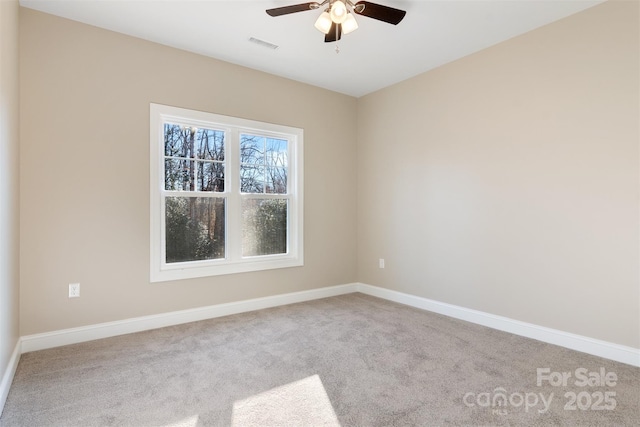 spare room featuring light carpet and ceiling fan