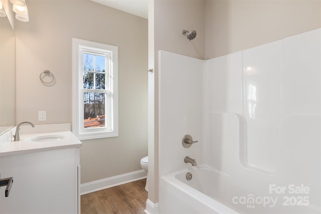 full bathroom with shower / bathing tub combination, hardwood / wood-style floors, vanity, and toilet