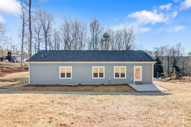 rear view of property featuring a lawn and a patio