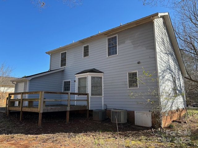 back of property featuring central AC and a deck