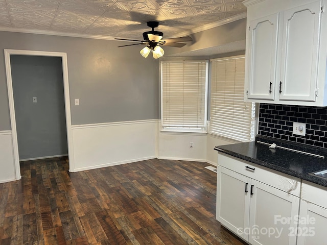 kitchen featuring backsplash, ceiling fan, dark wood-type flooring, dark stone countertops, and white cabinetry