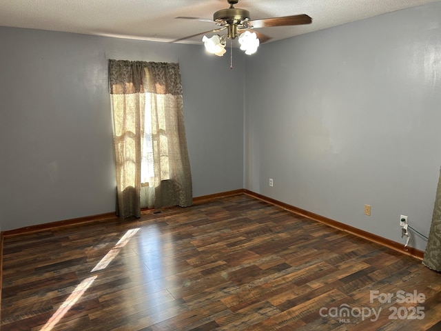 unfurnished room featuring ceiling fan, dark wood-type flooring, and a textured ceiling