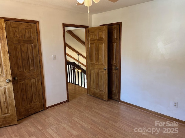 unfurnished bedroom featuring ceiling fan and light hardwood / wood-style flooring