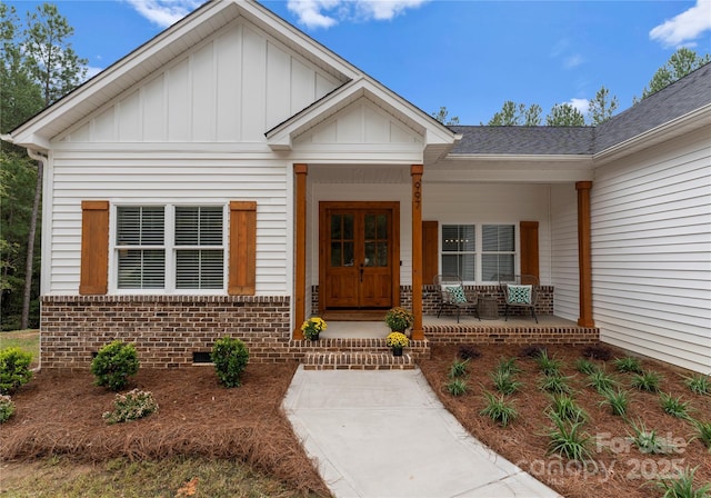 view of exterior entry featuring covered porch