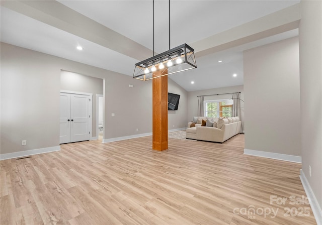 unfurnished living room with light hardwood / wood-style floors and lofted ceiling