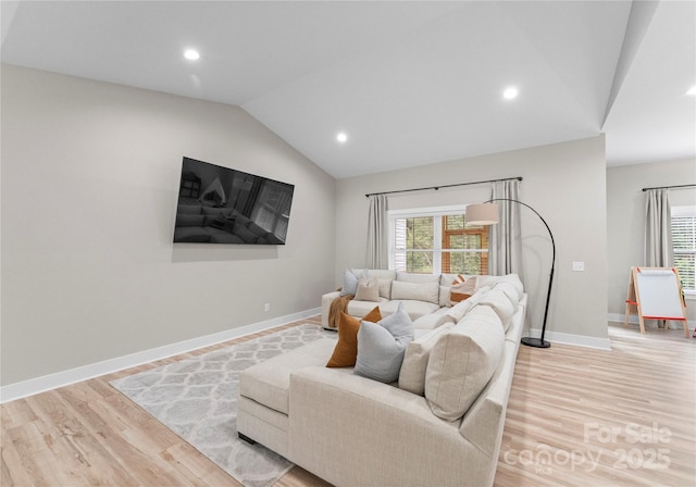 living room with light wood-type flooring and lofted ceiling