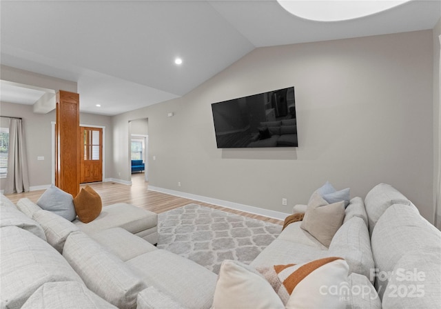 living room featuring light hardwood / wood-style flooring and lofted ceiling