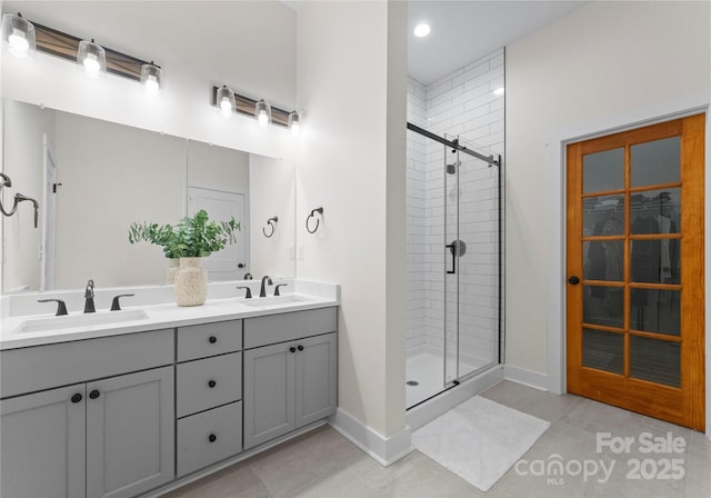 bathroom with tile patterned flooring, vanity, and a shower with shower door