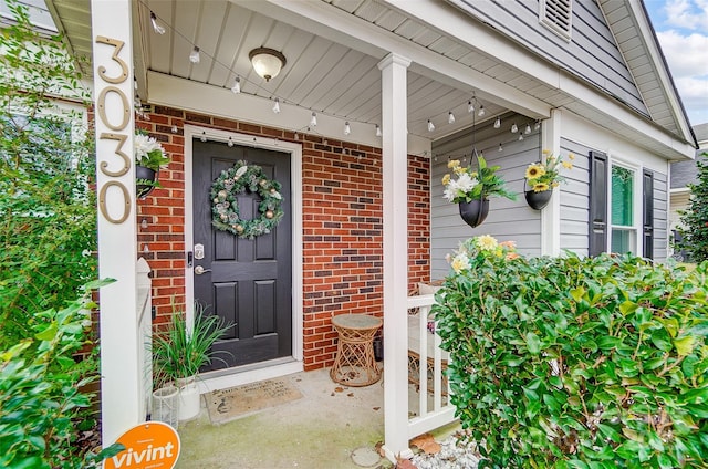 view of exterior entry with covered porch