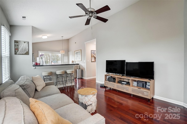 living room featuring vaulted ceiling, ceiling fan, a healthy amount of sunlight, and dark hardwood / wood-style floors