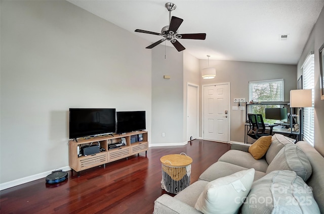 living room featuring dark hardwood / wood-style floors, ceiling fan, and vaulted ceiling