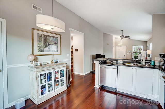 kitchen featuring ceiling fan, sink, stainless steel dishwasher, lofted ceiling, and white cabinets