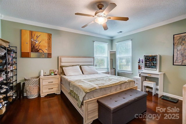 bedroom with a textured ceiling, ceiling fan, dark hardwood / wood-style floors, and ornamental molding