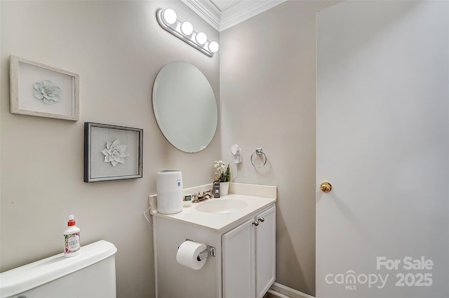 bathroom featuring crown molding, vanity, and toilet