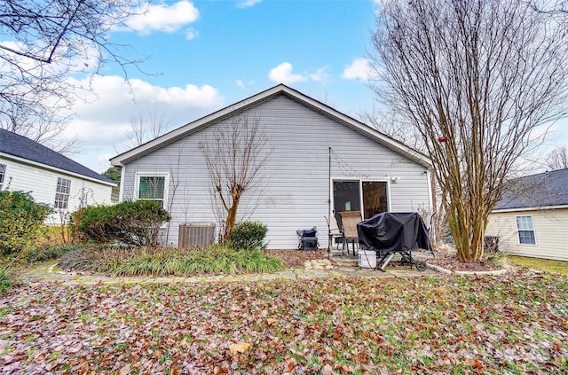 rear view of property with central AC