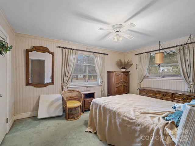 carpeted bedroom with ceiling fan and ornamental molding