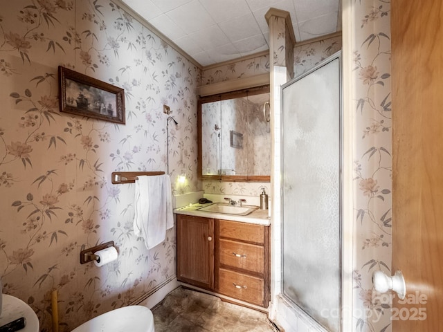 bathroom with vanity, toilet, and a shower with shower door