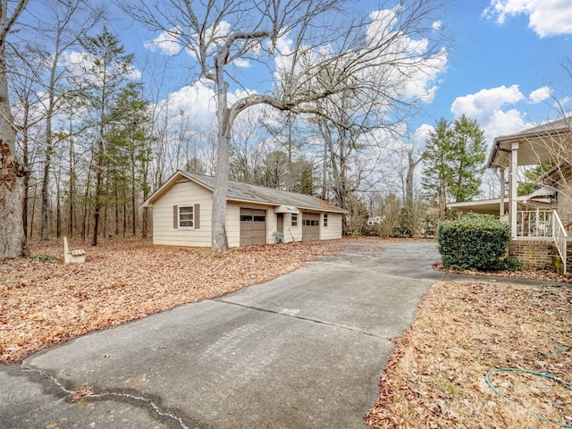 view of side of home with a garage and an outdoor structure