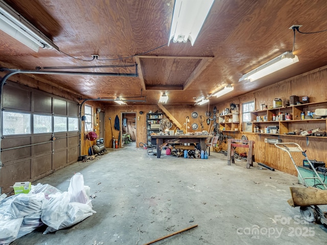 garage featuring a workshop area and wood ceiling