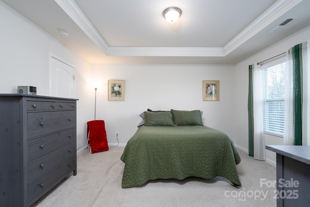 bedroom featuring crown molding, a raised ceiling, and light carpet